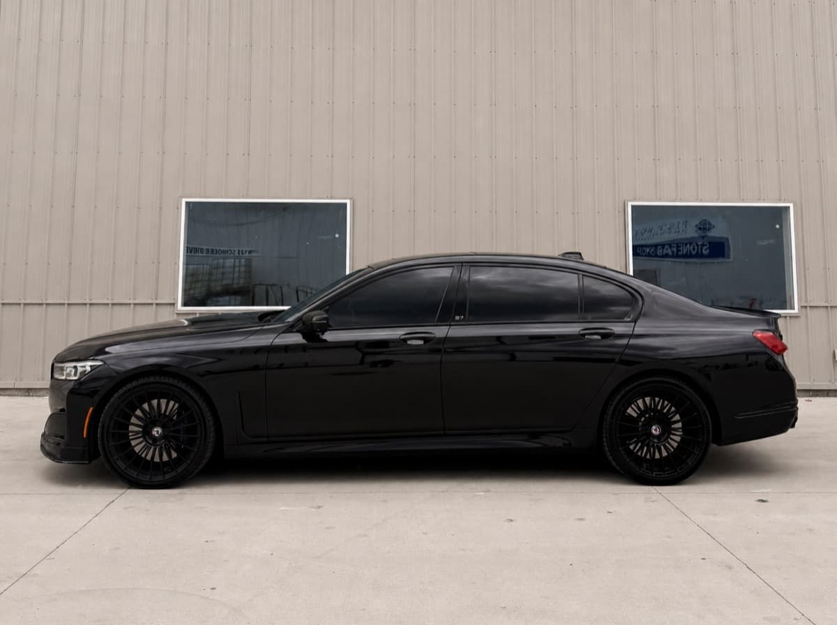Black BMW Alpina B7 side profile after tint